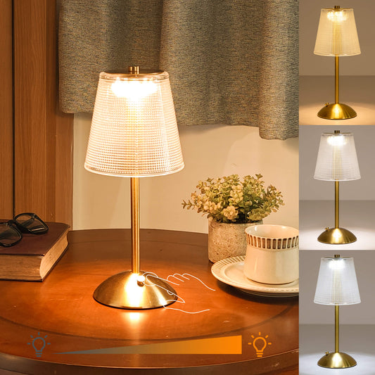 Cordless-Rechargeable-Battery-Retro-Gold-2000mAh, The golden cordless lamp which has 3 color modes is placed on a coffee table, illuminating and decorating the cafe.
