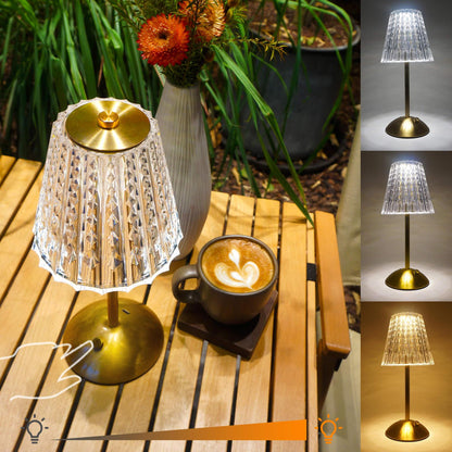 Cordless-Rechargeable-Battery-Modern-lamp, Diamond-Gold-Amingulry, the gold cordless lamp which has 3 color modes is placed on a table, illuminating and decorating the camping.