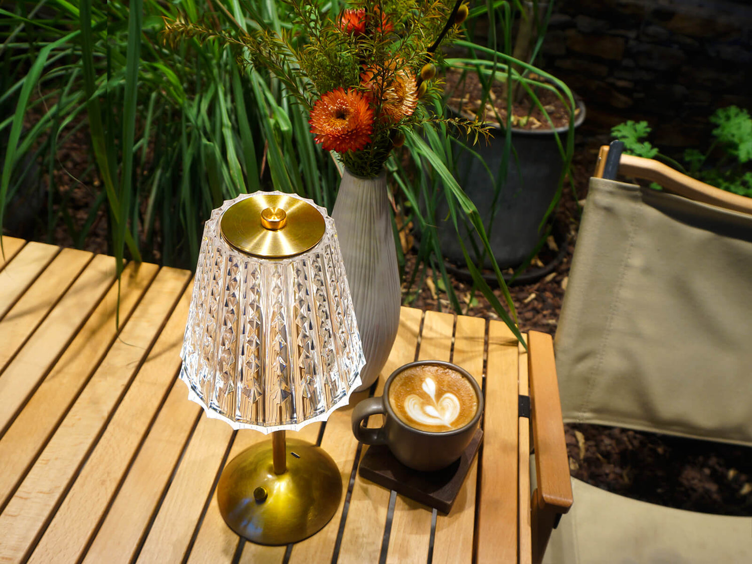 Cordless-Rechargeable-Battery-Modern-portable, gold lamp is lighting on the camping table. 