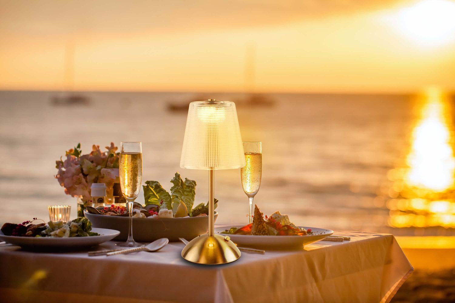 Cordless-Rechargeable-Battery-Retro-portable, gold lamp is lighting on the outdoor party dinner table. 